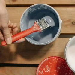 Paintbrush in grey paint