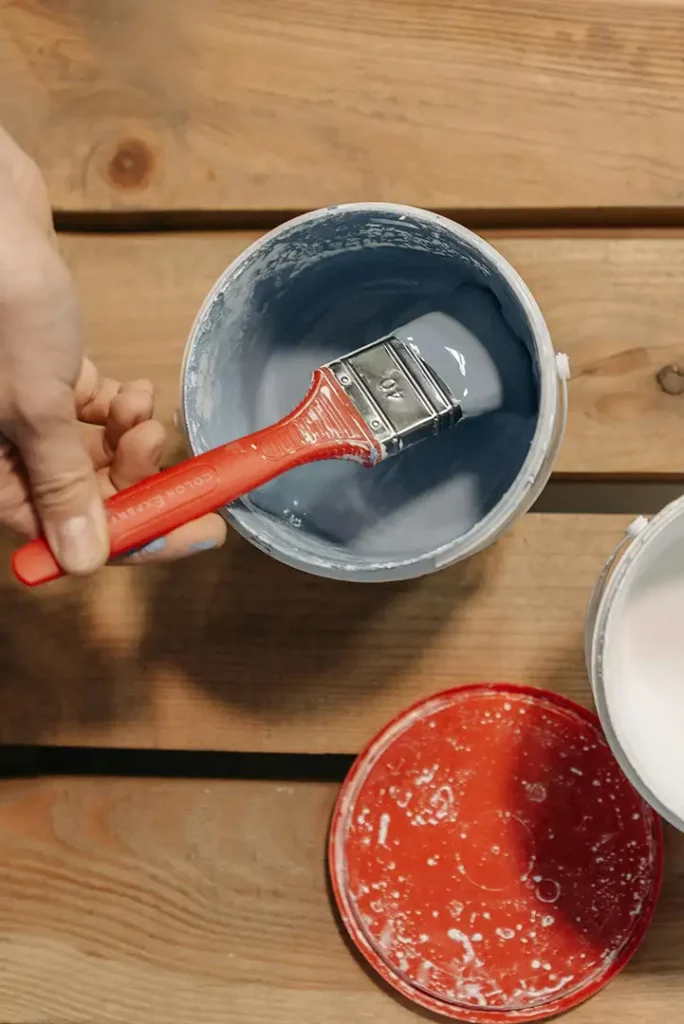 Paintbrush in grey paint
